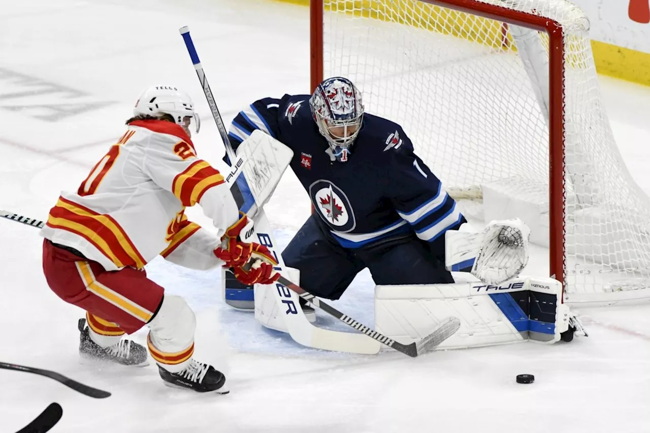 Jets' goaltender Comrie puts 'curse' to rest with 5-2 win over Flames