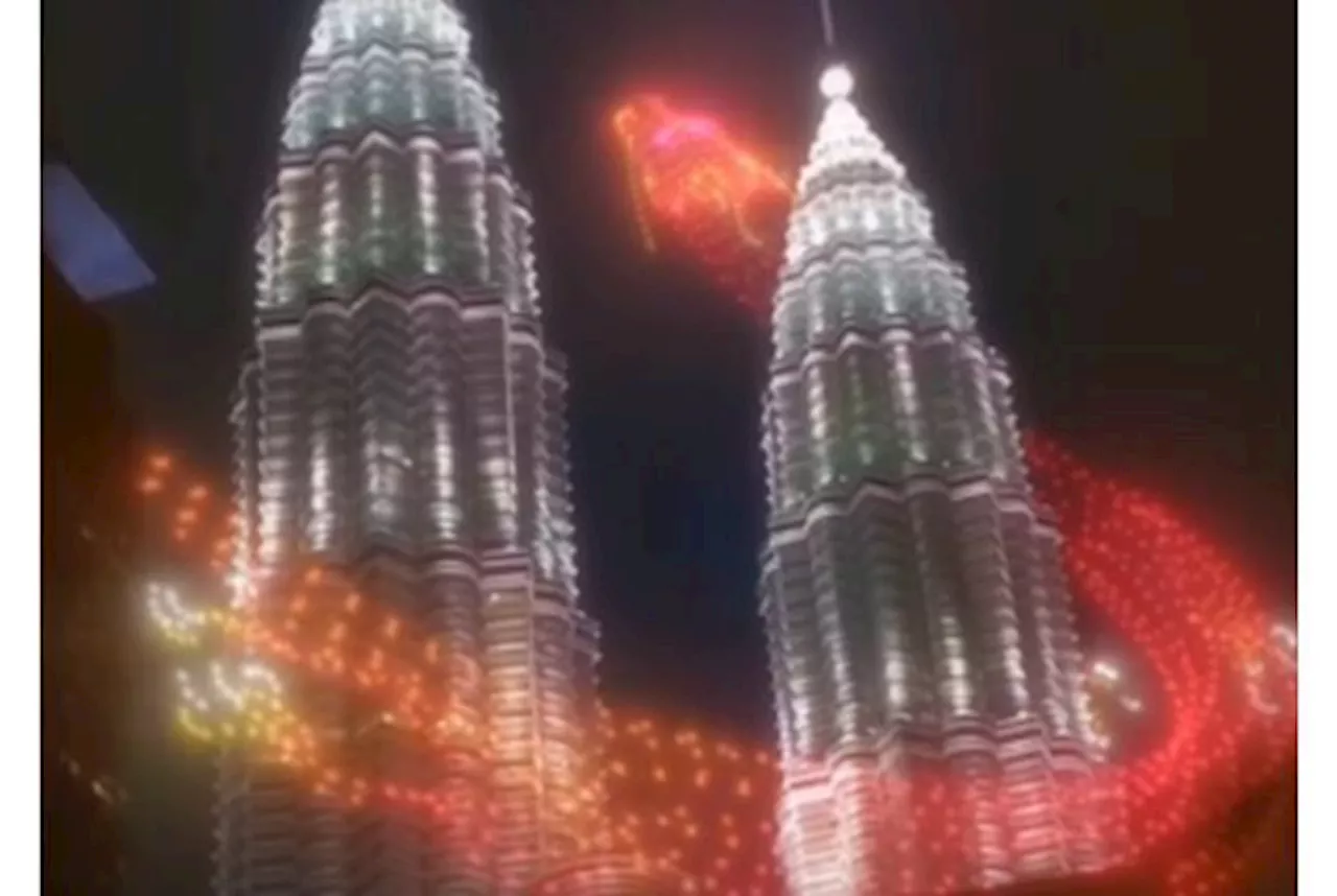 Dazzling show: Dragon flies around PETRONAS Twin Towers, capturing public attention