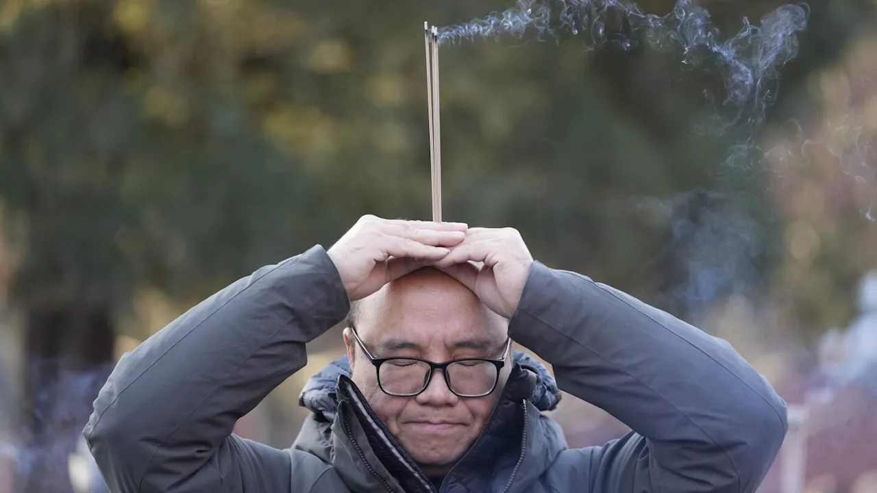 Lunar New Year prayers and incense usher in the Year of the Snake