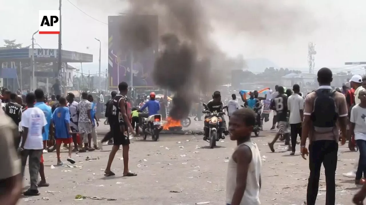 Protesters rally behind Congolese president in Kinshasa as others flee violence to Rwanda