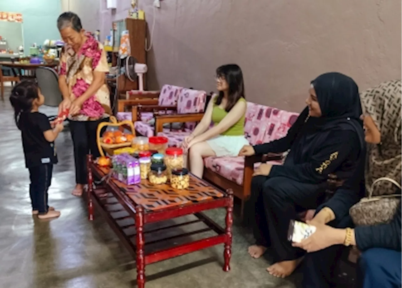 Malaysian Woman Celebrates Chinese New Year with Malay Neighbors