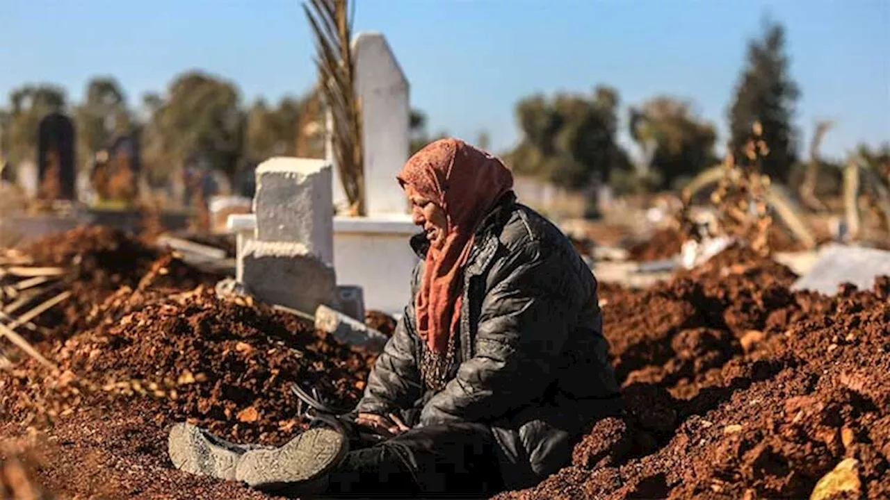 At Syria cemetery, people search for missing loved ones