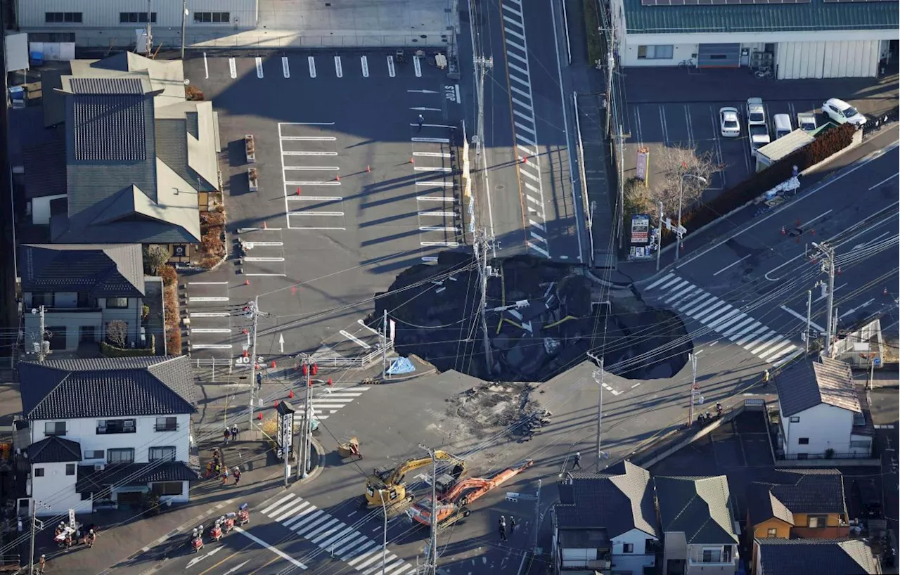 Japan sinkhole grows to almost Olympic pool length; driver still missing