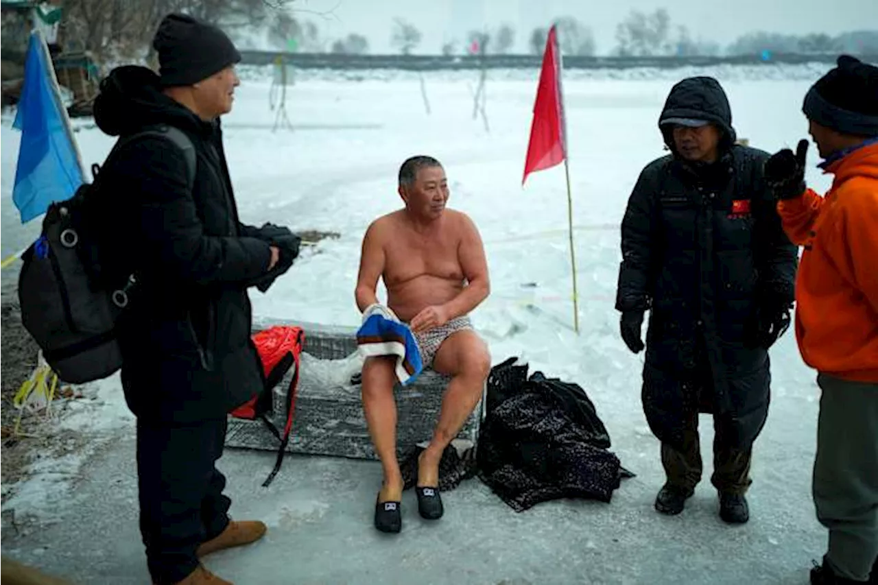 In freezing temperatures, swimmers in China plunge into a river for health and joy