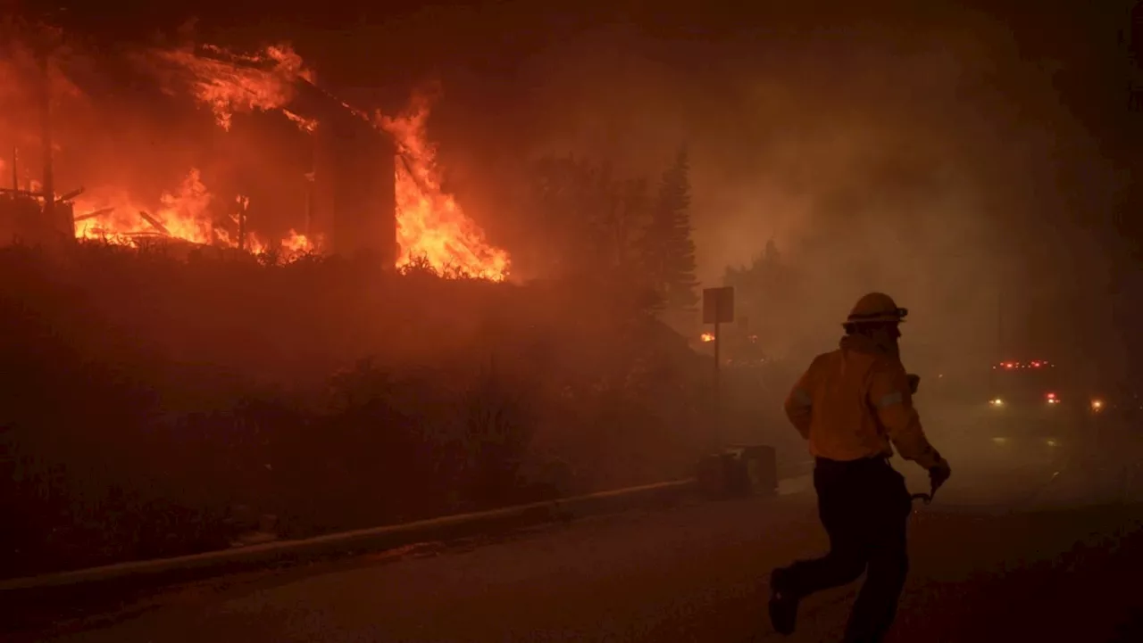 Wildfire Ravages Los Angeles Suburb, Forcing Evacuations