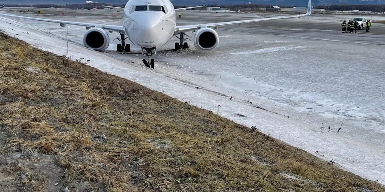 Alaska Airlines mechanics steer plane off runway at Anchorage airport