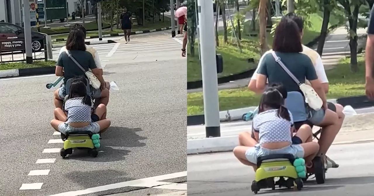 Family of Four Rides Mobility Scooter With Children on Trailing Seat