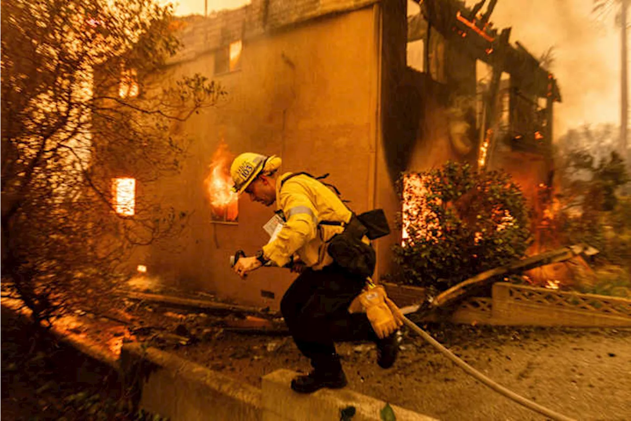 Wildfires latest: Winds subside as firefighters battle devastating blazes in Los Angeles area