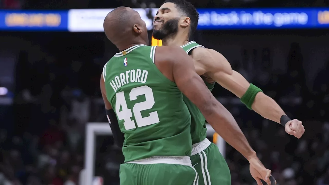 Boston Celtics forward Jayson Tatum celebrates with center Al Horford (42) after his go-ahead, game-winning shot in the final second of the second half of an NBA basketball game in New Orleans, Friday, Jan. 31, 2025.