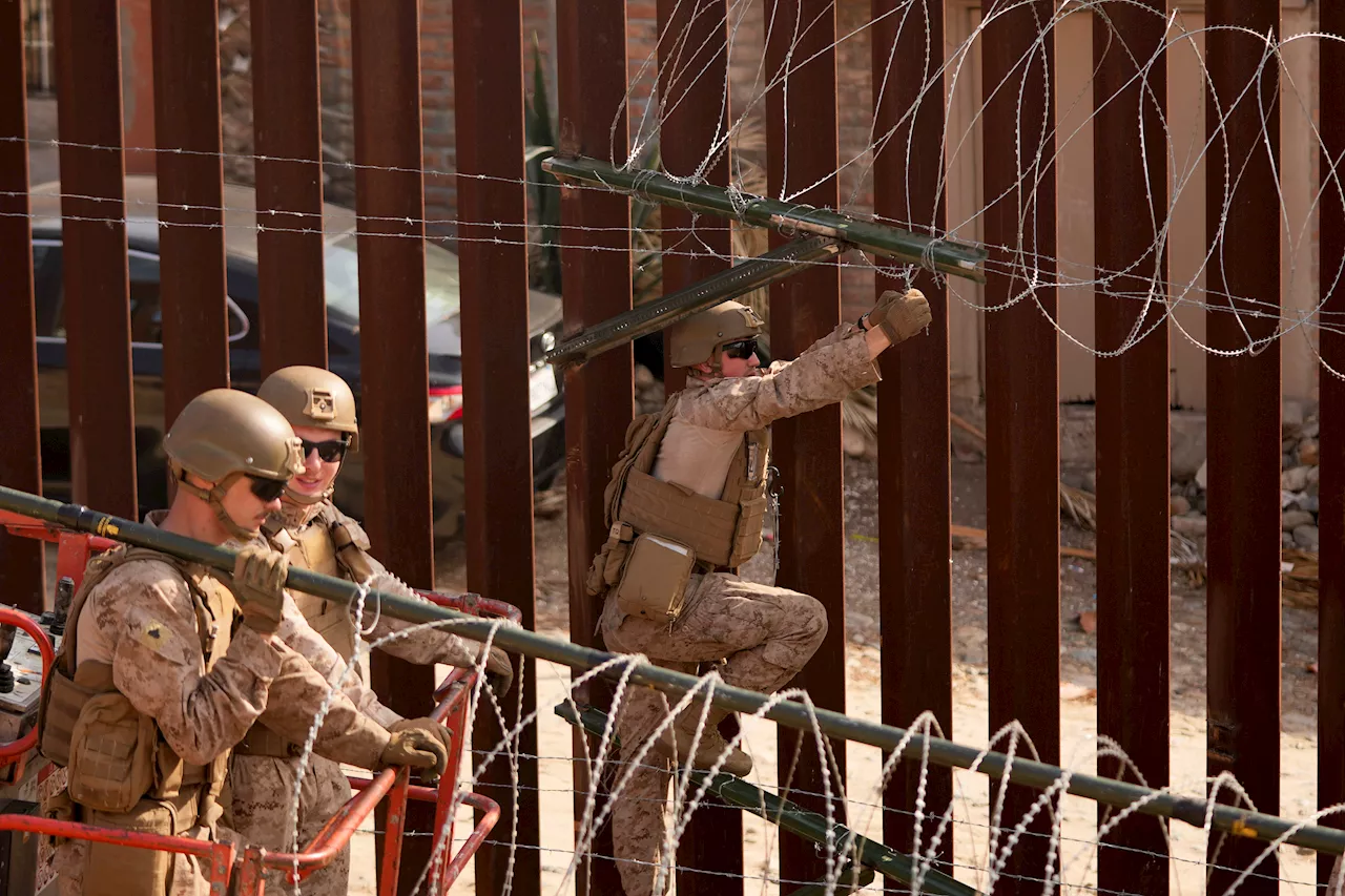 Marines install barbed wire along border fence separating Tijuana from San Diego