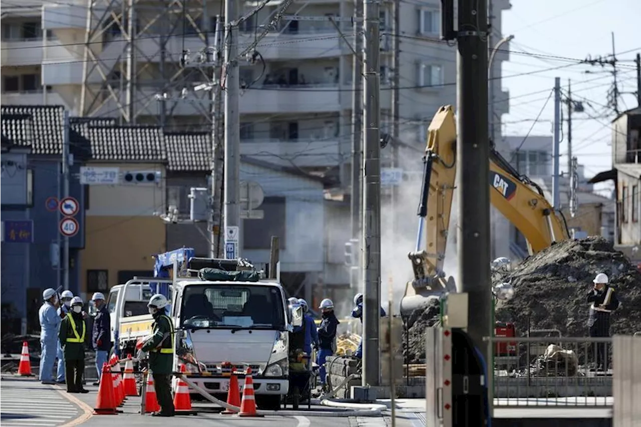 Rescuers build slope to reach man in Japan sinkhole