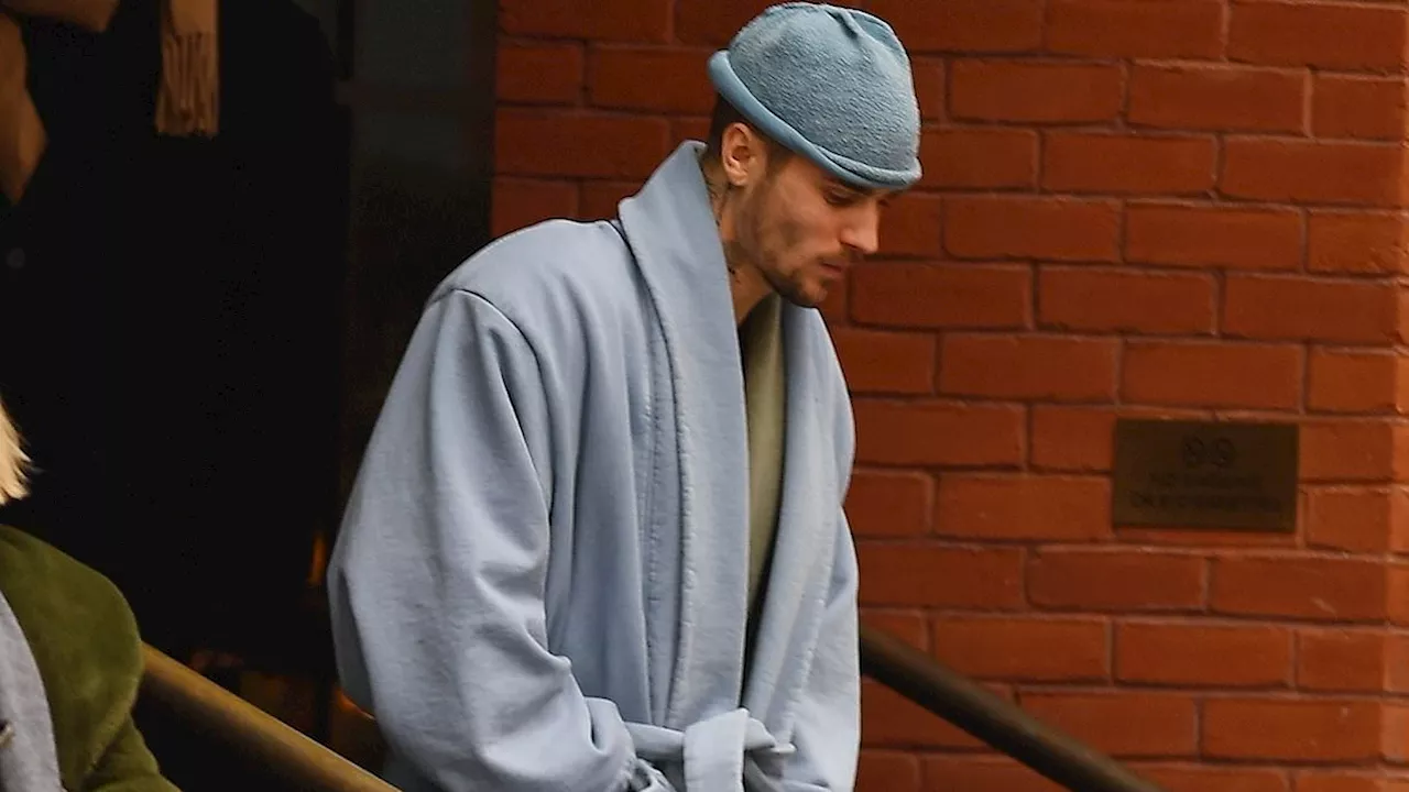 Justin Bieber wears a bathrobe out in public after seedy spa visit... as wife Hailey seeks comfort...