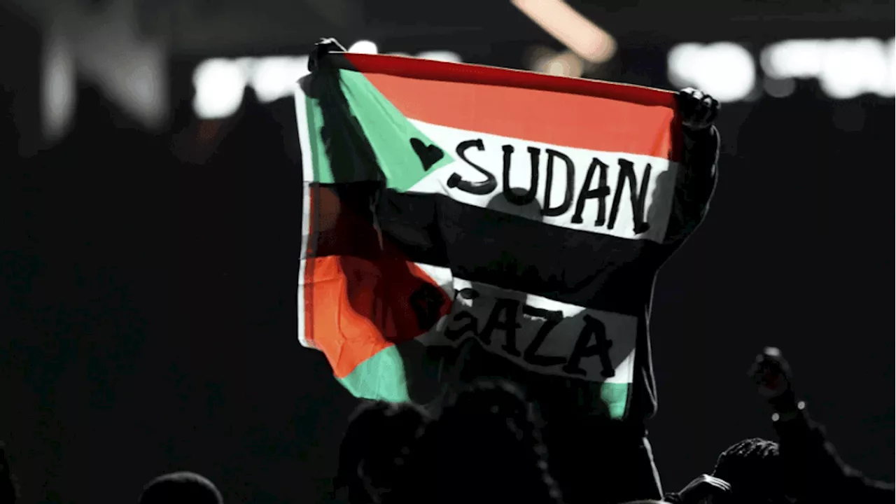 Super Bowl Halftime Show Disrupted by Protester Holding Sudan and Gaza Flag