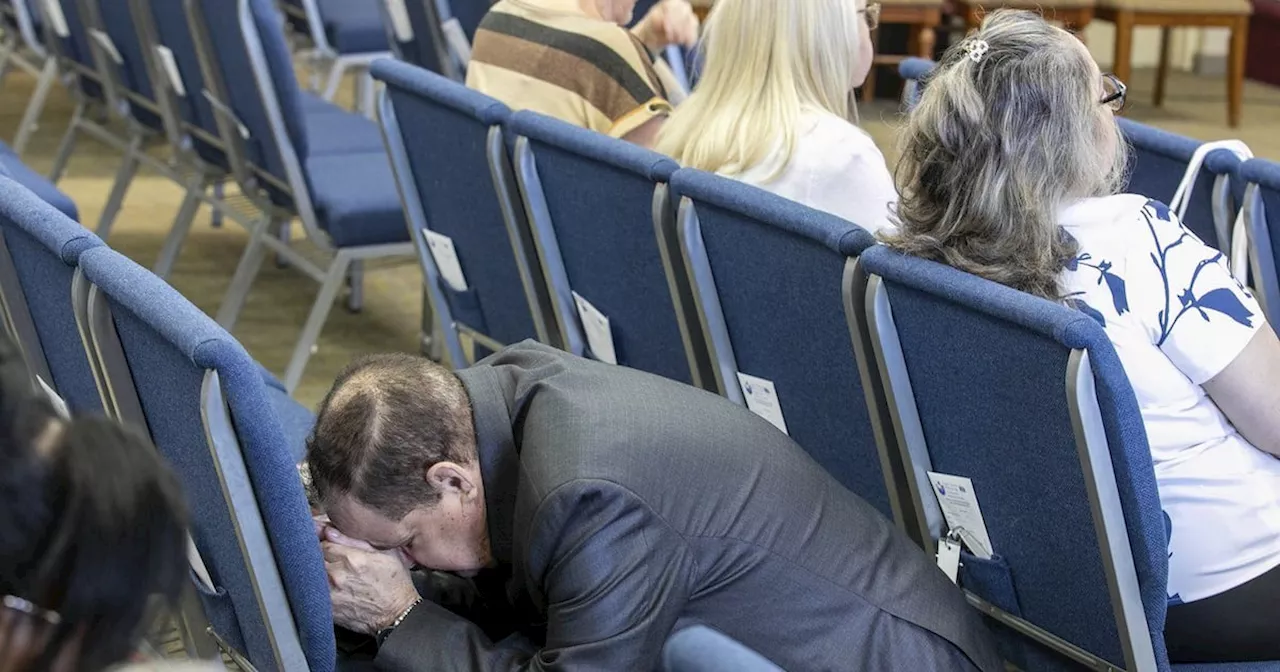 Congregant Kneels in Prayer at Florida Church