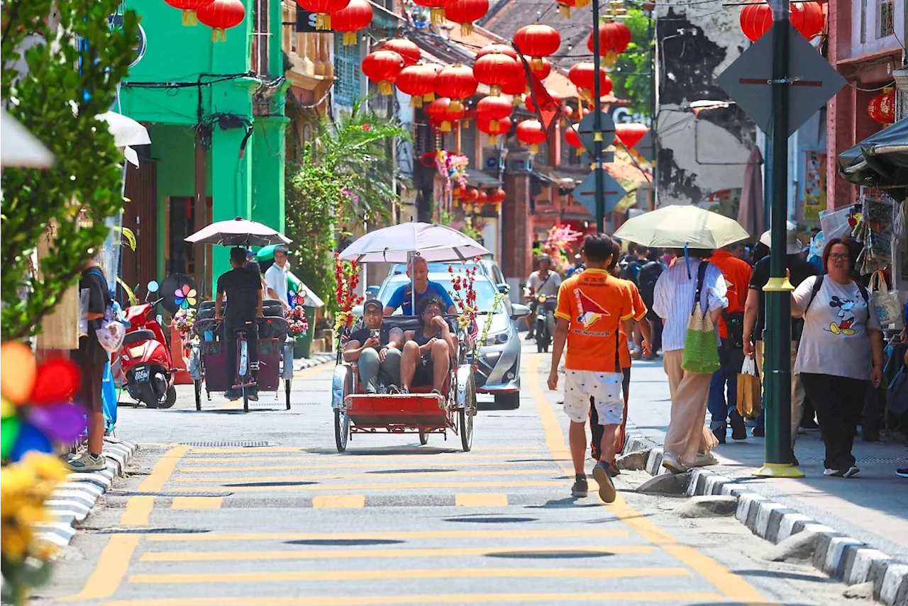 Trishaw Riders Pedal Through Chinese New Year Celebrations in George Town