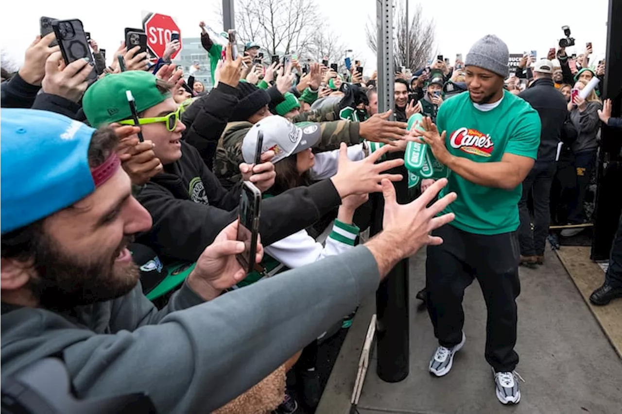 Eagles' Barkley Celebrates Super Bowl Victory with Fans and a Raising Cane's Shift