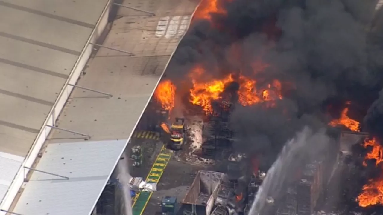 Massive fire erupts in Western Sydney factory with exploding gas bottles fuelling out-of-control blaze