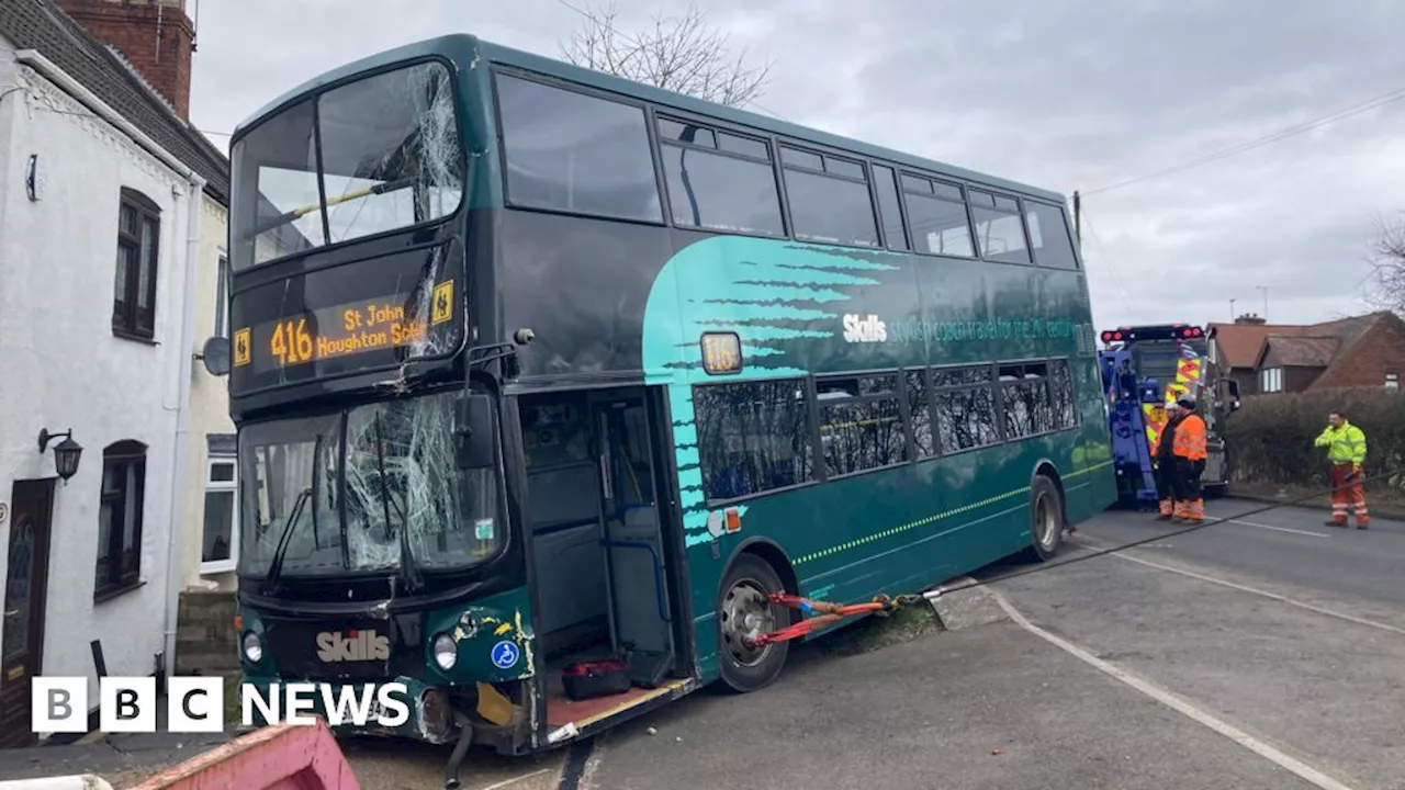 School Bus Crashes Into House