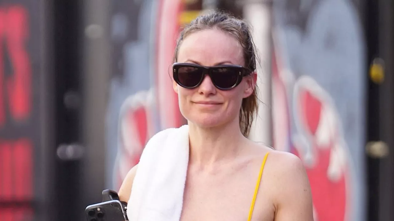 Olivia Wilde flashes her toned abs in an unusual bra top after claims she is dating a hunk