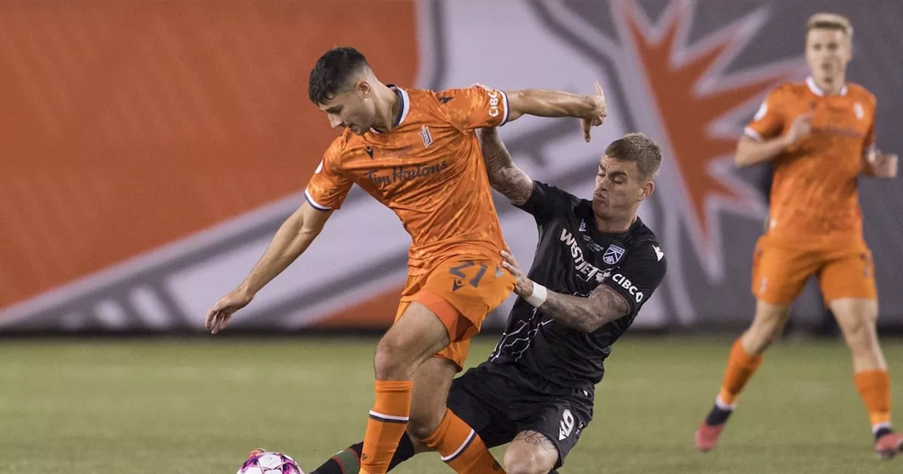 Cavalry FC Forward Fights for a Ball in Canadian Premier League Finals