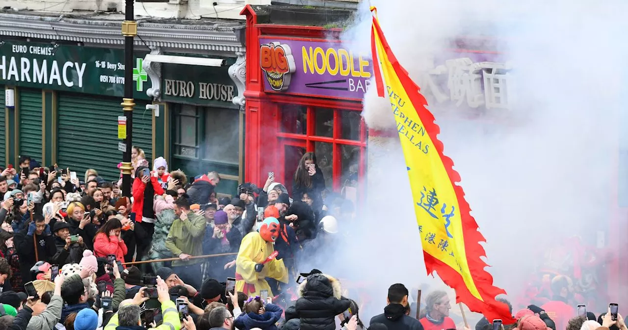 Firecrackers, dragons and music: Hundreds line city streets to celebrate Chinese New Year