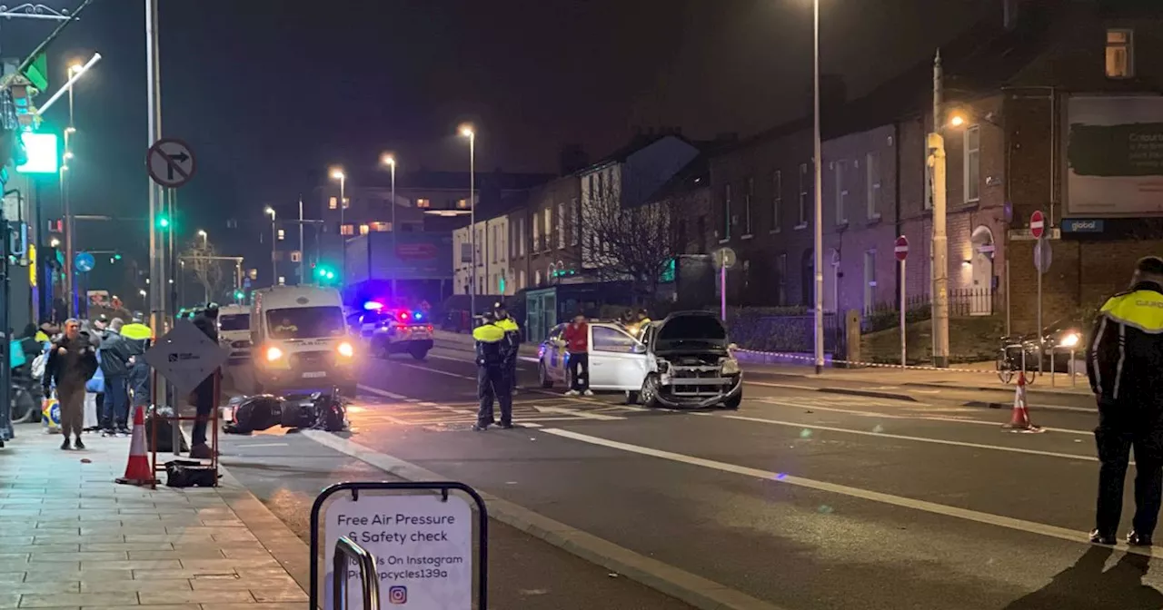 Motorcyclist, 40s, hospitalised and woman, 20s, arrested after Dublin road crash