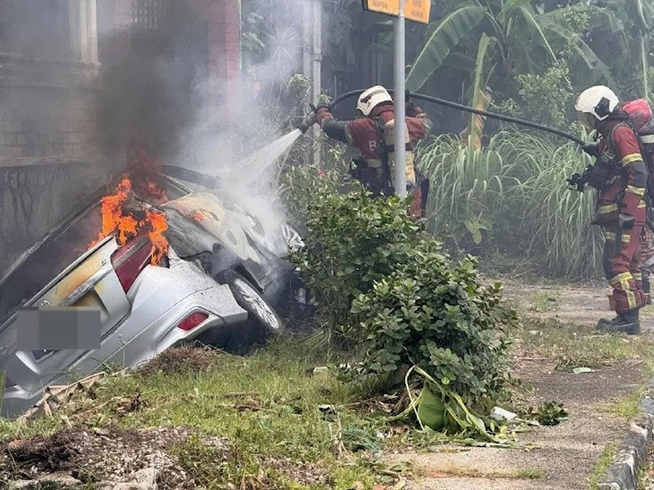 Driver Escapes Unhurt After Car Skids, Hits House, Catches Fire