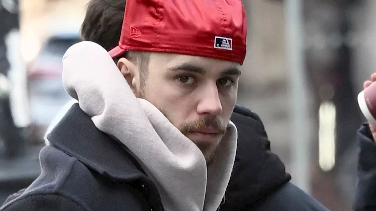 Justin Bieber debuts goatee with 'soul patch' while struggling to keep his slacks on as fans...