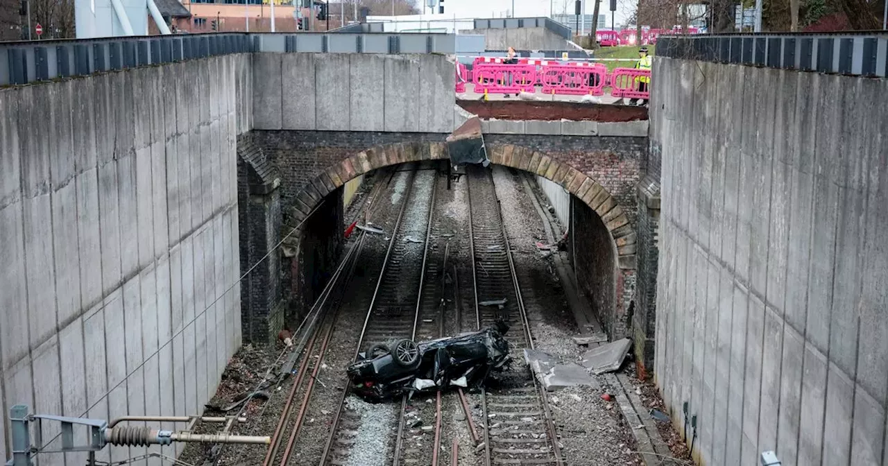 LIVE: Car crashes at roundabout and lands on train tracks with travel chaos