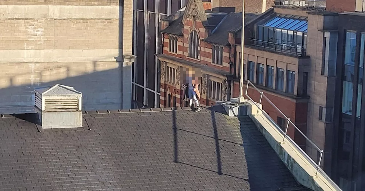 Woman Walks Along Roof of Manchester Opera House