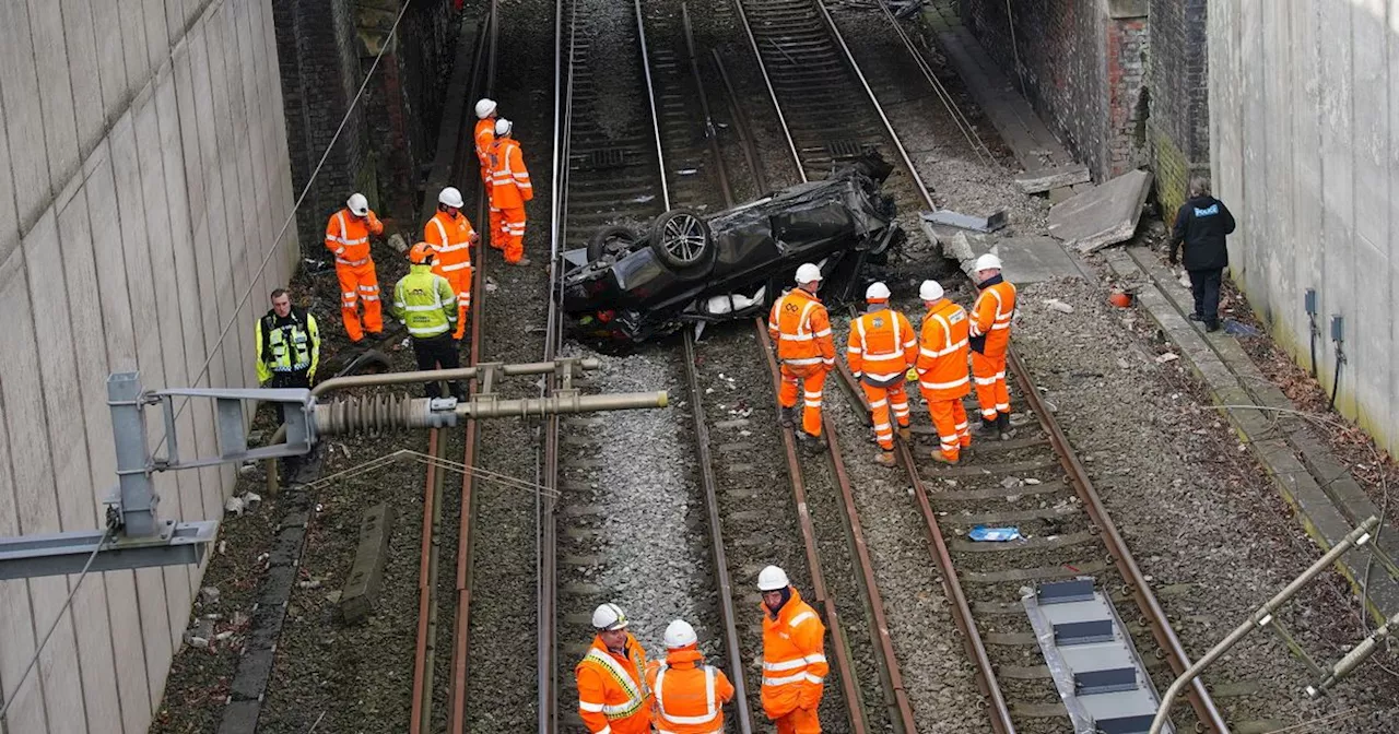 Dramatic images as car crashes onto railway tracks with huge wreckage