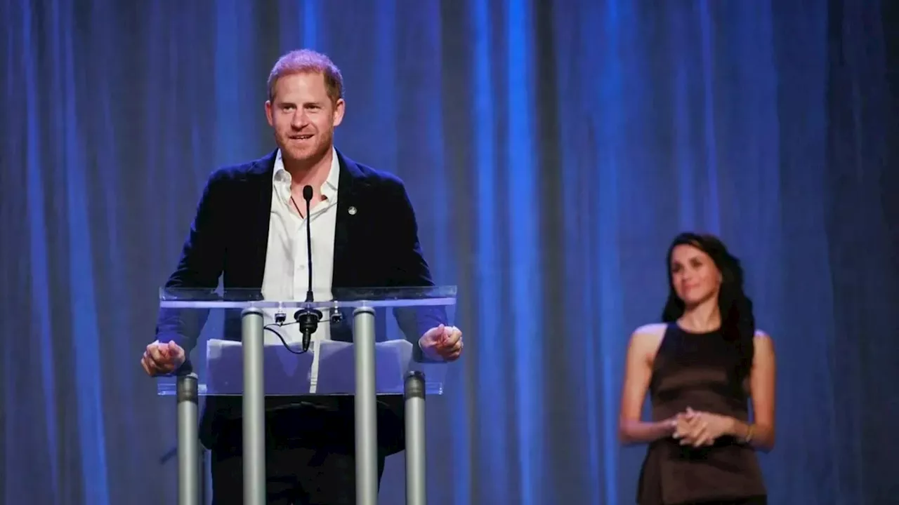 Meghan Markle kisses Prince Harry on stage as he opens Invictus Games to cheers...