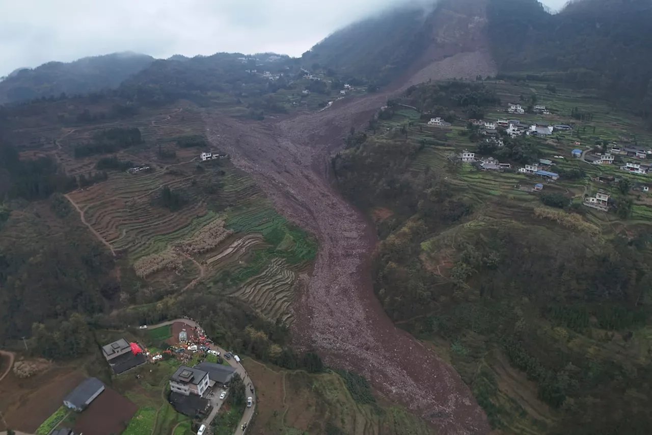 China landslide buries homes, traps at least 29