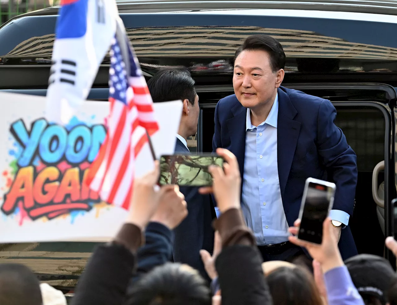Ousted South Korean President Yoon embraces supporters after leaving presidential residence