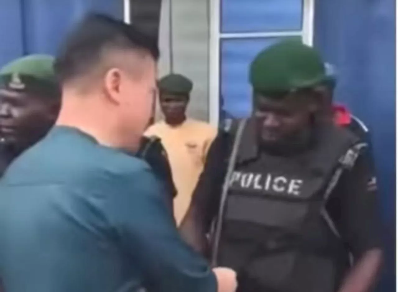 Video of Chinese national distributing money to Nigerian police officers sparks outrage