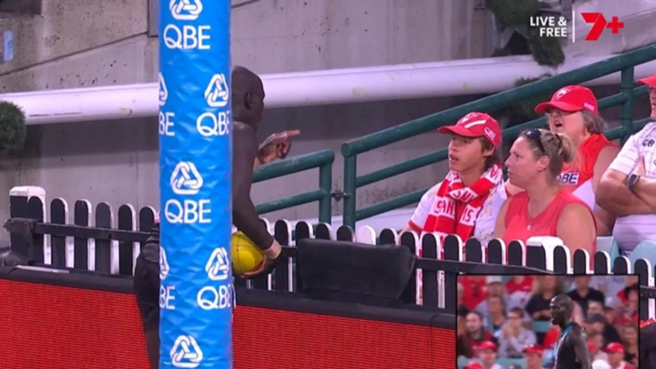 Port Adelaide defender Aliir Aliir has object thrown at him by young Sydney Swans supporter
