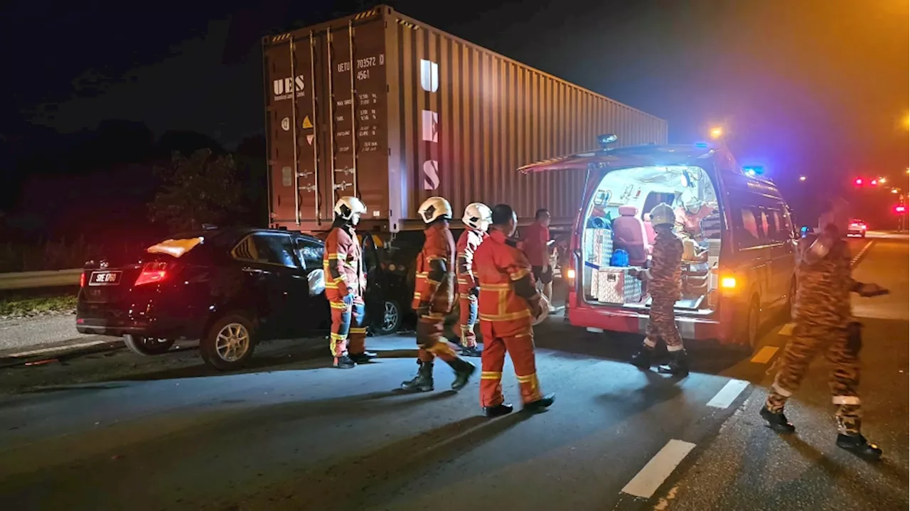 Firemen rescue driver after car slams into back of container lorry at Bintulu traffic light