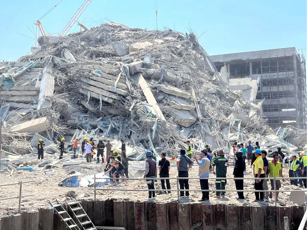 Thai construction tycoon and 14 others surrender to police over fatal Bangkok tower collapse