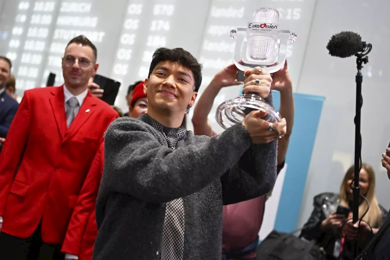 Austria welcomes JJ back home with cheers, hugs and roses after winning Eurovision Song Contest