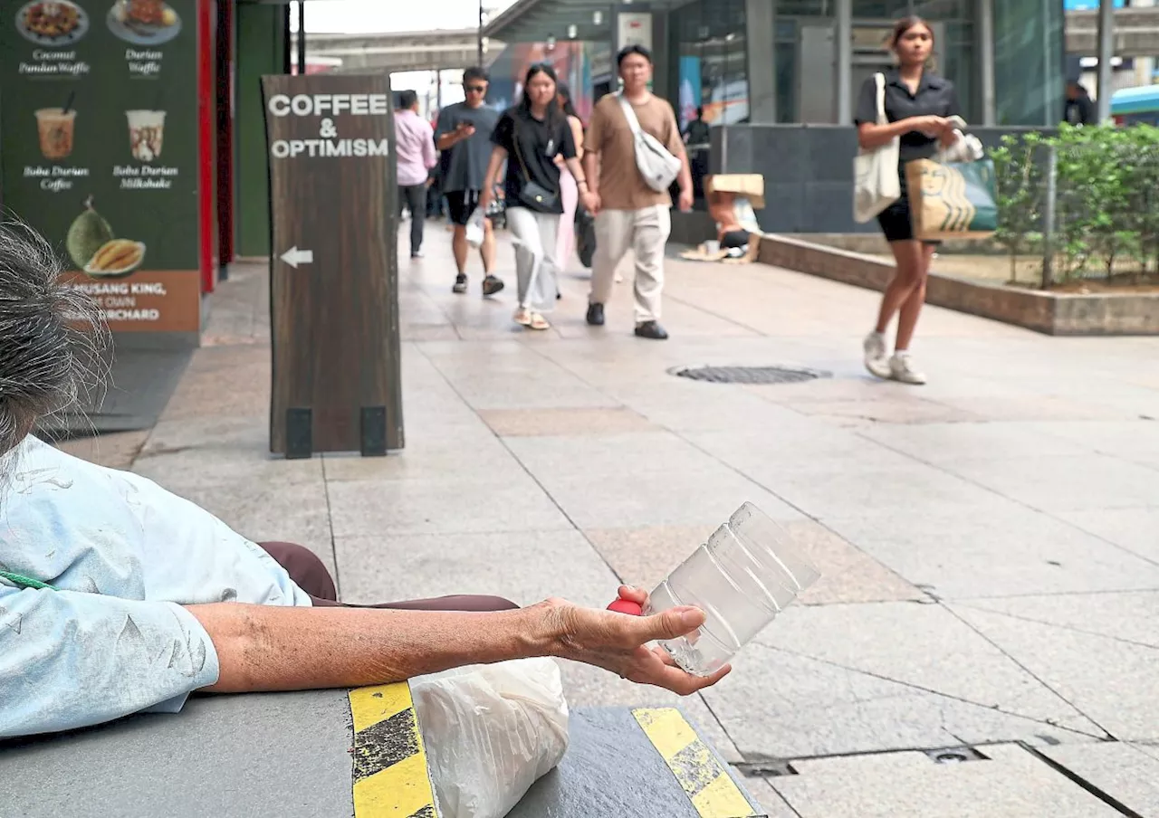 Beggars line KL’s busy streets