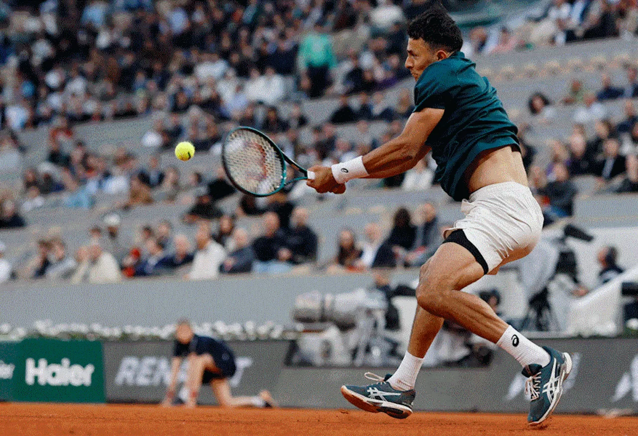 Big names crash but Italians shine on damp day at French Open