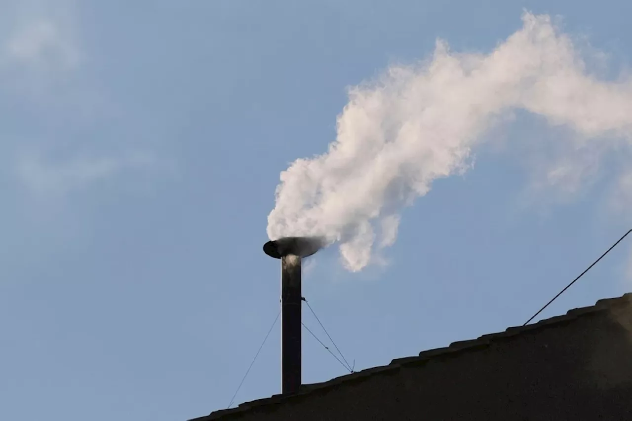 White smoke pours out of the Sistine Chapel chimney, signaling that a new pope has been elected