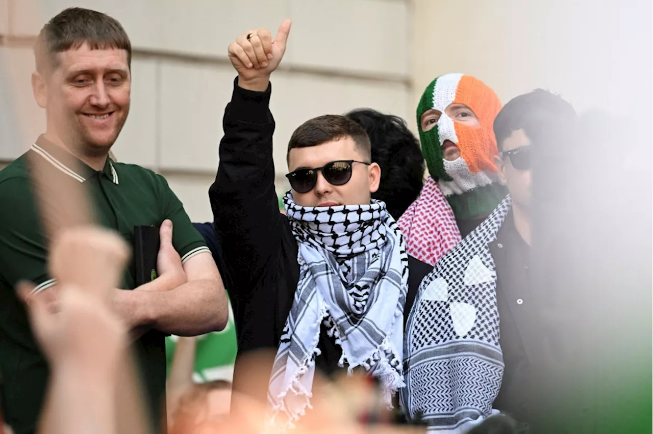 Hundreds rally behind Kneecap’s Mo Chara as he faces UK terrorism charge for Hezbollah flag display