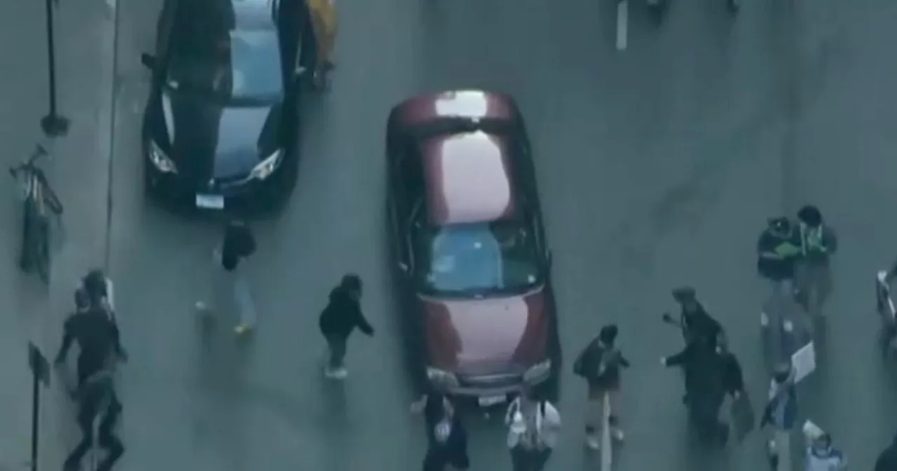 Woman charged with driving car through crowd during anti-ICE protest this month