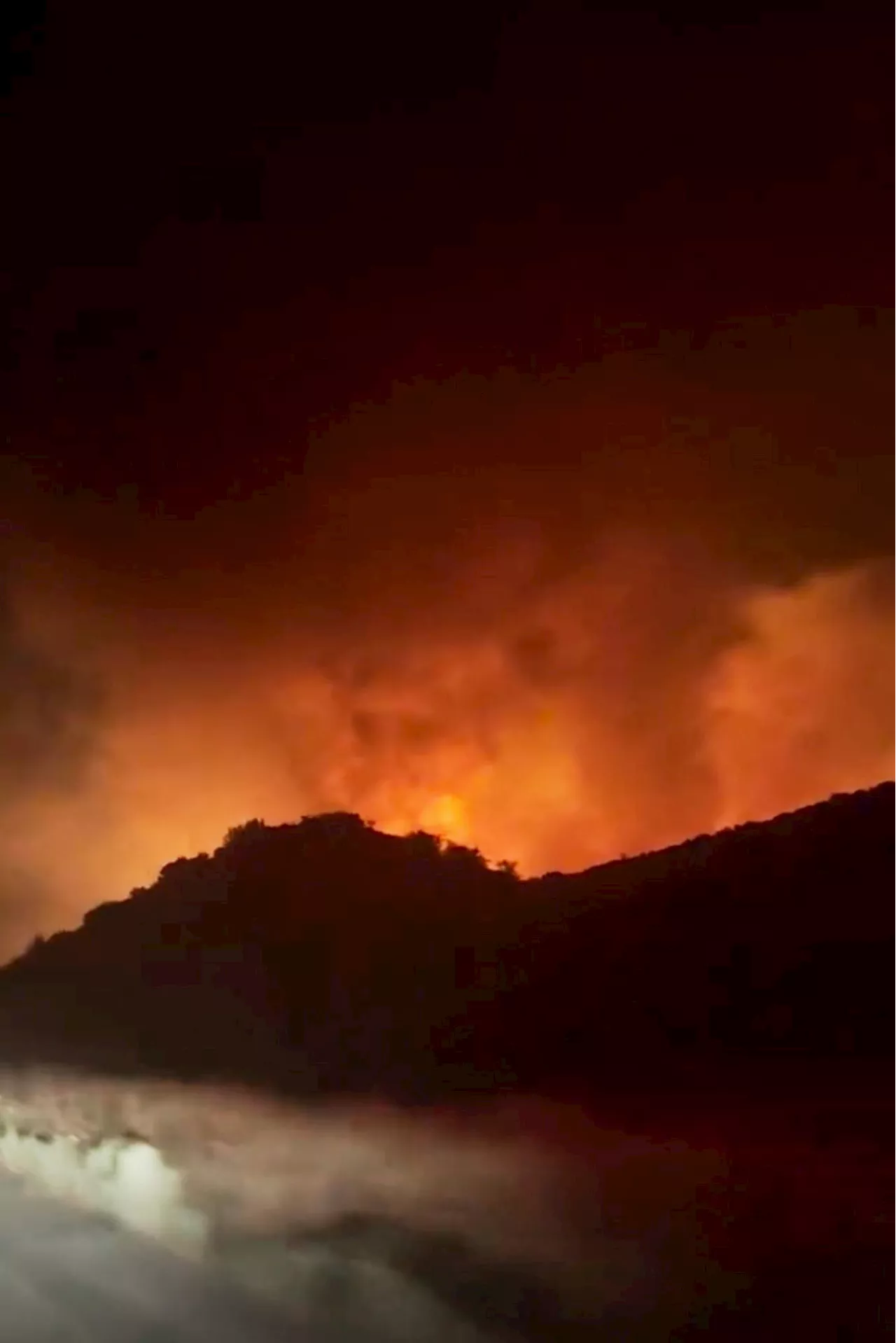 Firefighters make progress against fast-moving blaze along highway north of Los Angeles