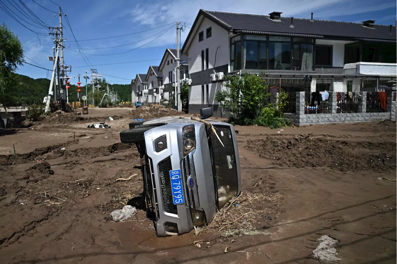 Monsoon peaks in south China, unleashing landslides and a surge in virus cases