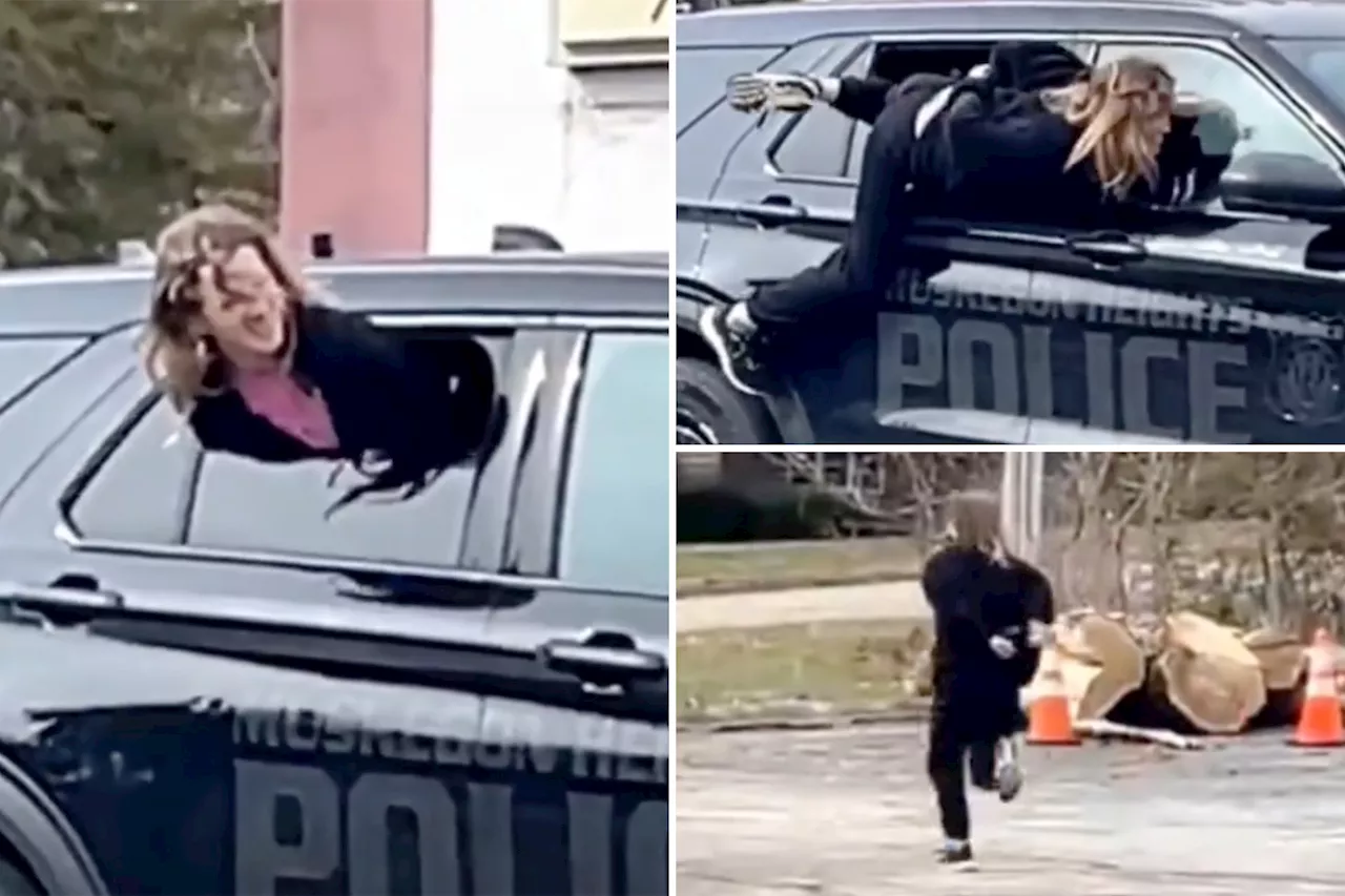 Wild video captures handcuffed woman wriggle out of Michigan police cruiser and sprint away